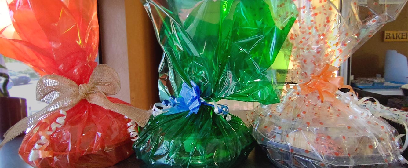 Three gift baskets, festively decorated and fillded with baked goods